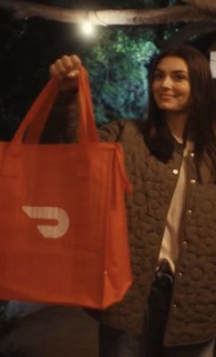Woman holding DoorDash bag
