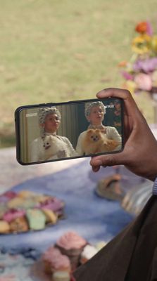 Person holding a phone watching Bridgerton show