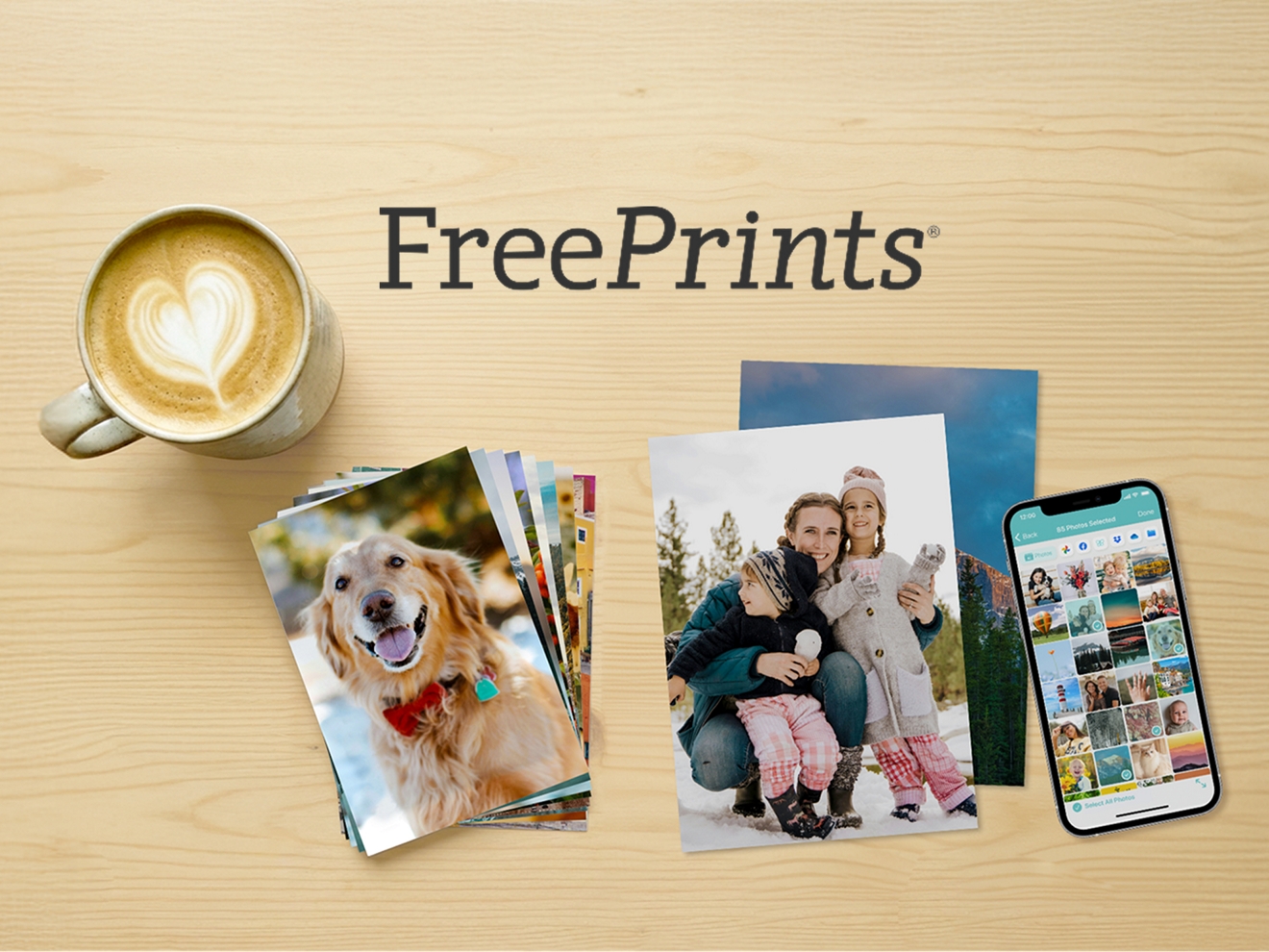 Two stacks of printed photos sit on a table beside a cup of coffee and an iPhone.