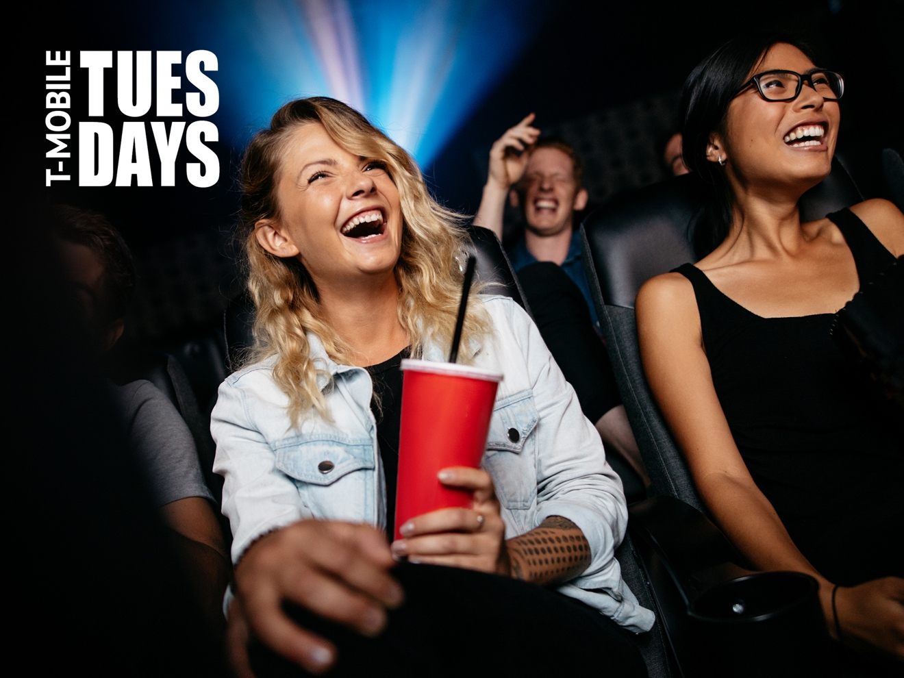 Friends are watching a movie together at a theater