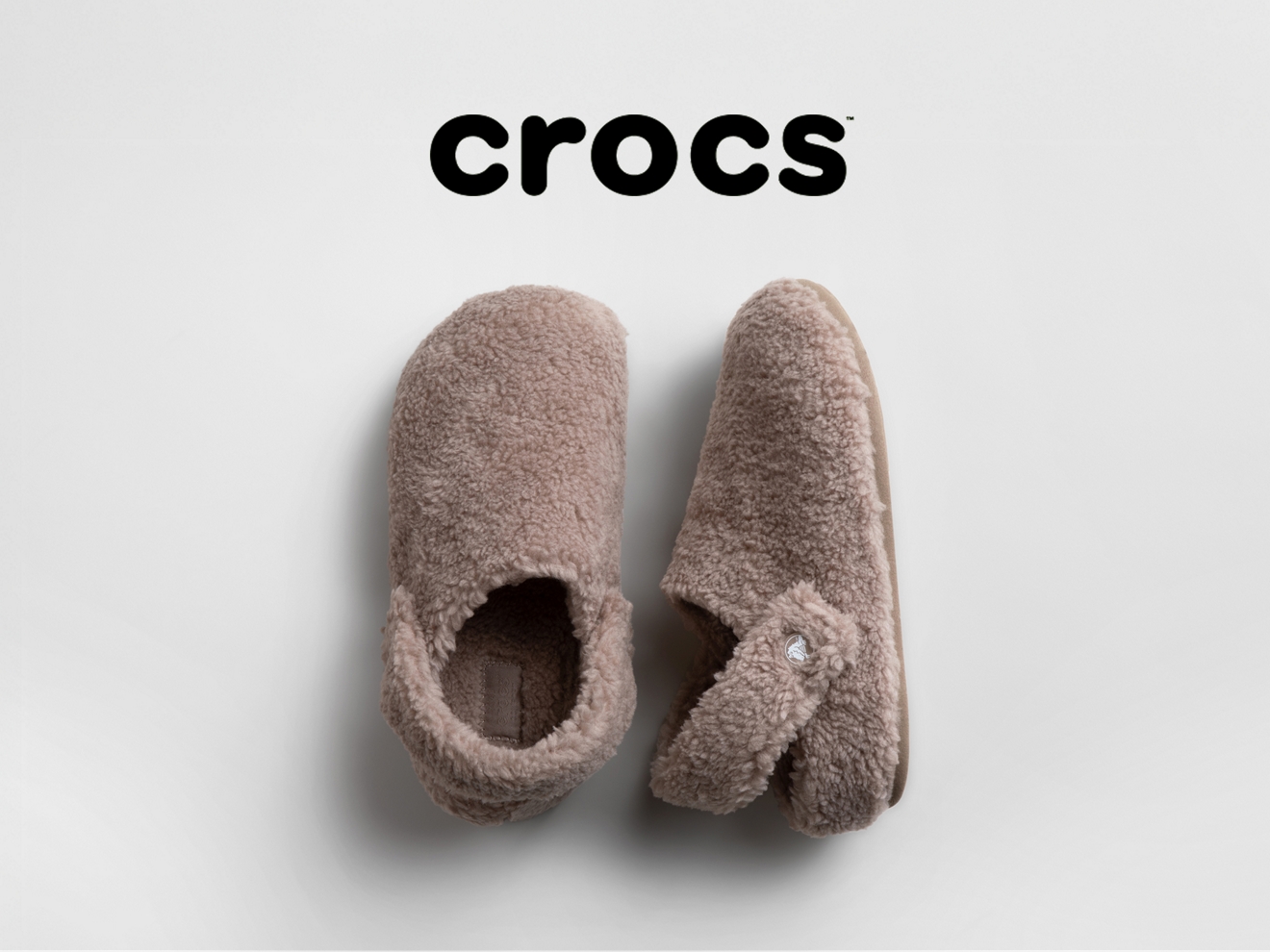 A pair of fuzzy beige crocs.