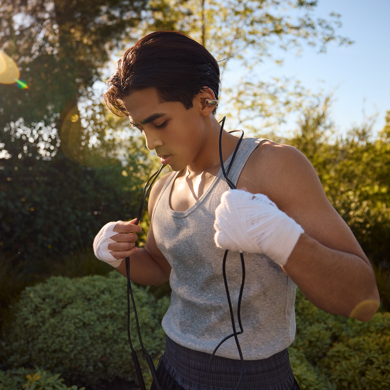 Man working out with Bose Ultra Open Earbuds.