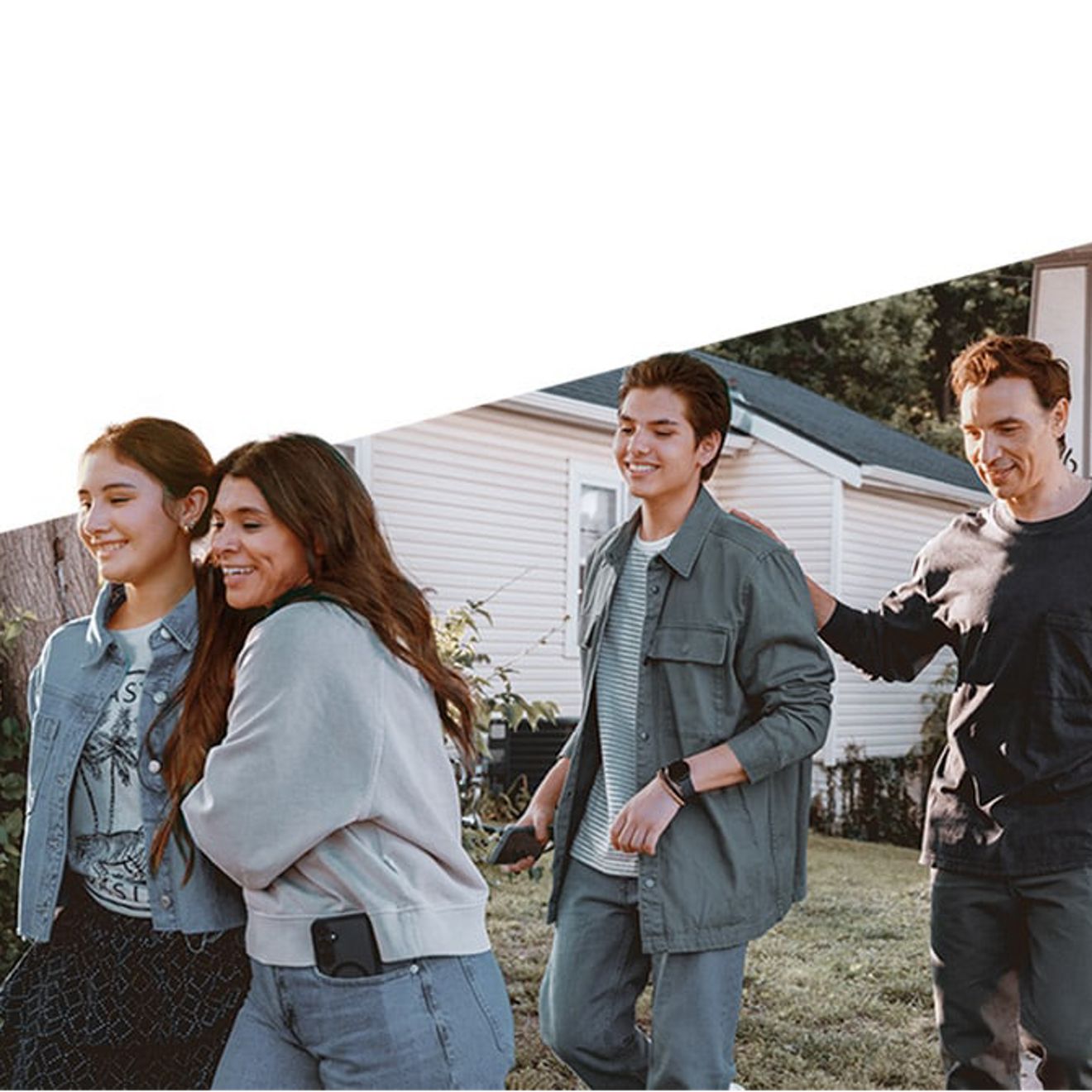 A group of friends walk down the sidewalk.