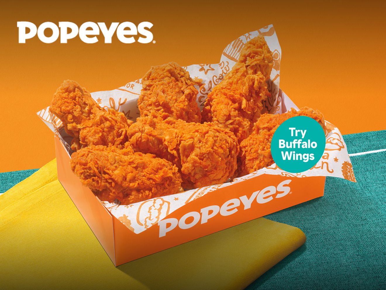 6 chicken wings in a Popeyes basket.
