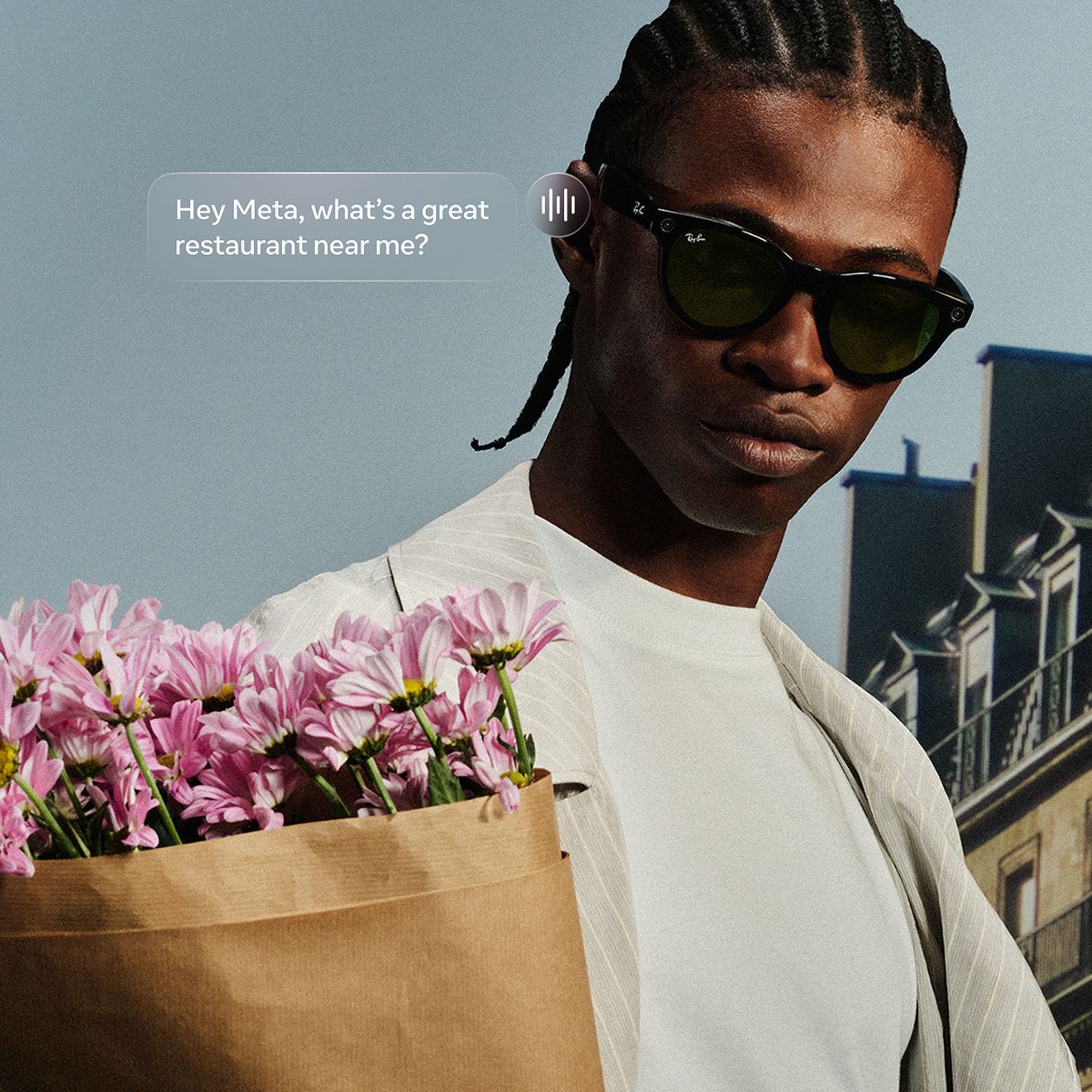 A man holding a bouquet of flowers is wearing his Ray-Ban Meta sunglasses.