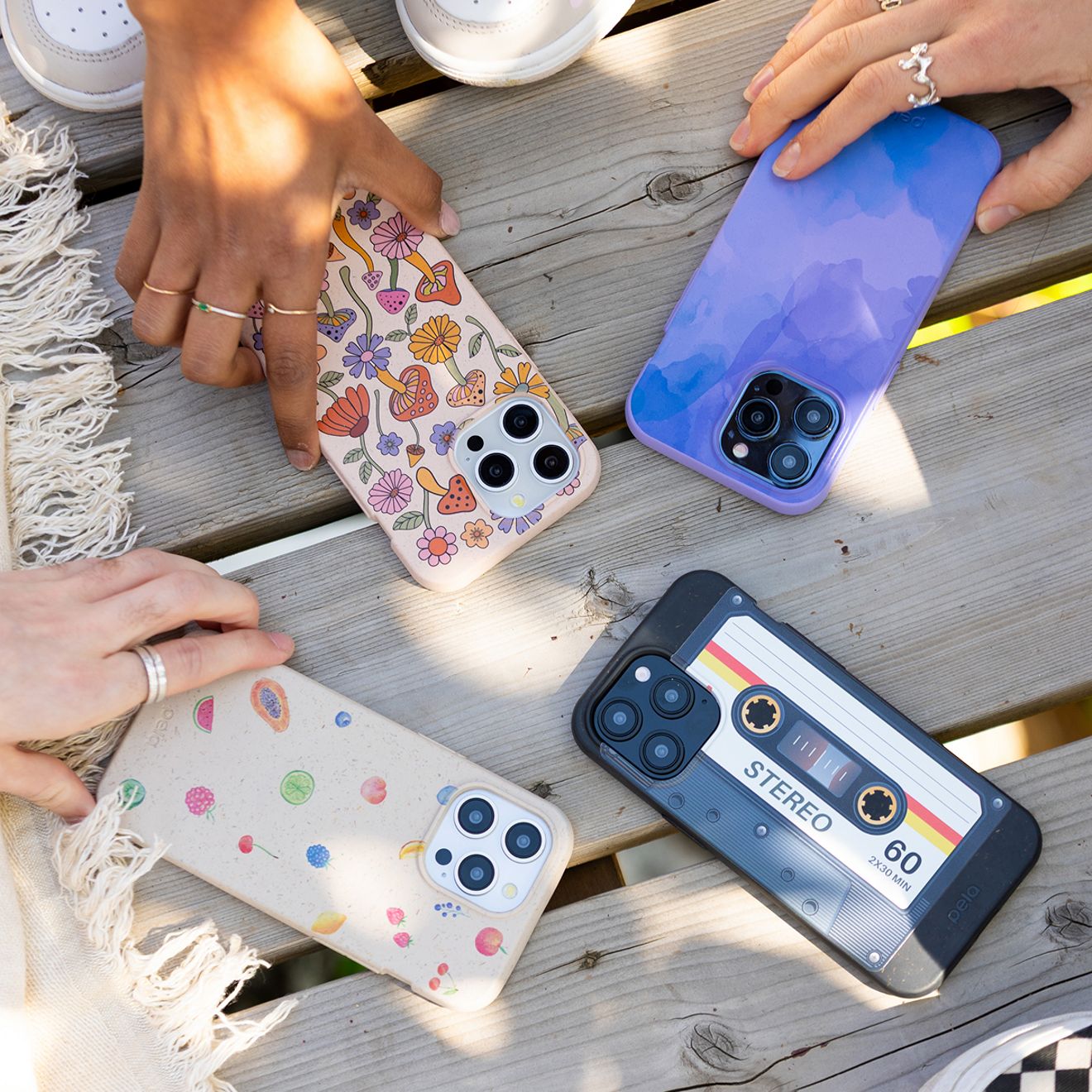 Four friends show off each of their four iPhone Pela phone cases.