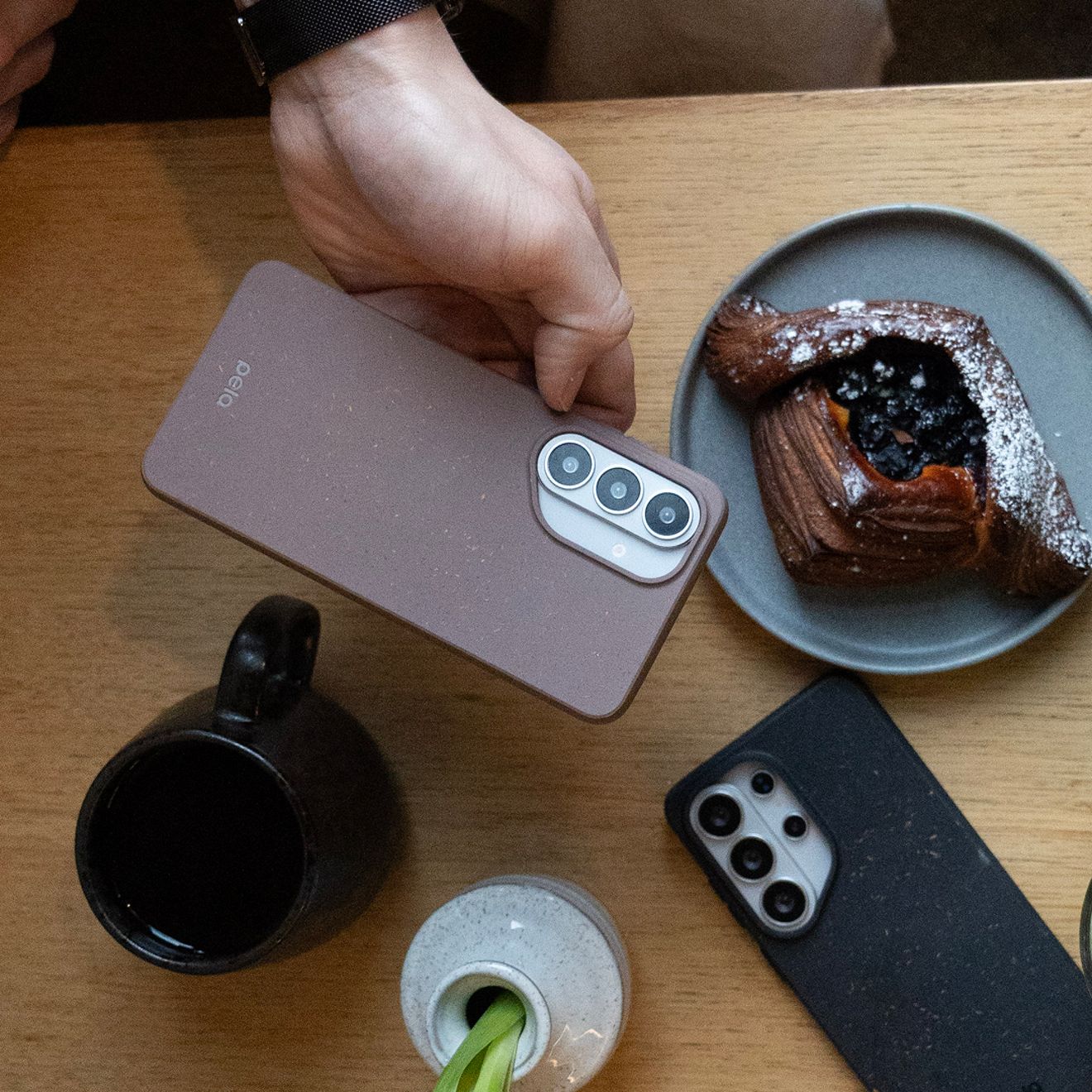 A man shows off his two different Samsung Pela phone cases.