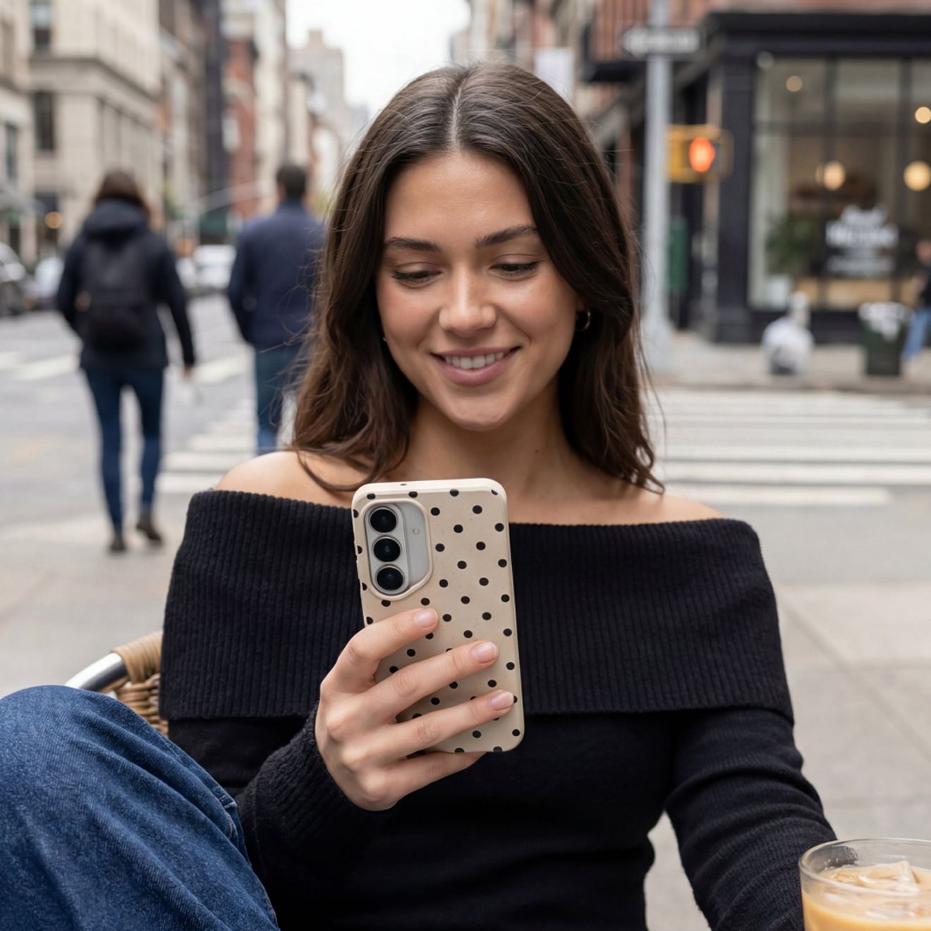 A woman uses her phone with its Samsung Pela phone case.