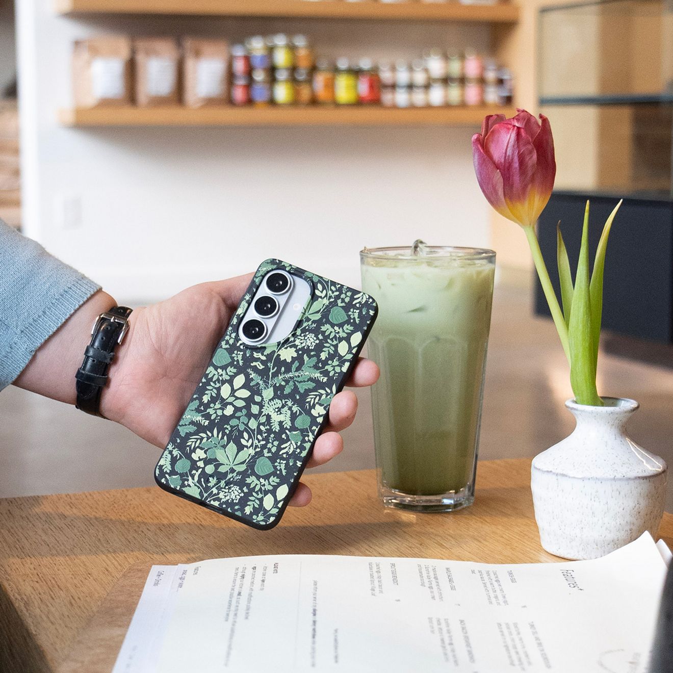 A man shows off his phone in its Samsung Pela phone case.