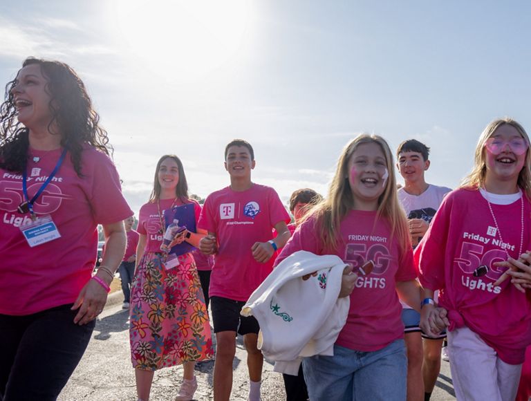 A group of people dressed in FN5GL swag walking and cheering.