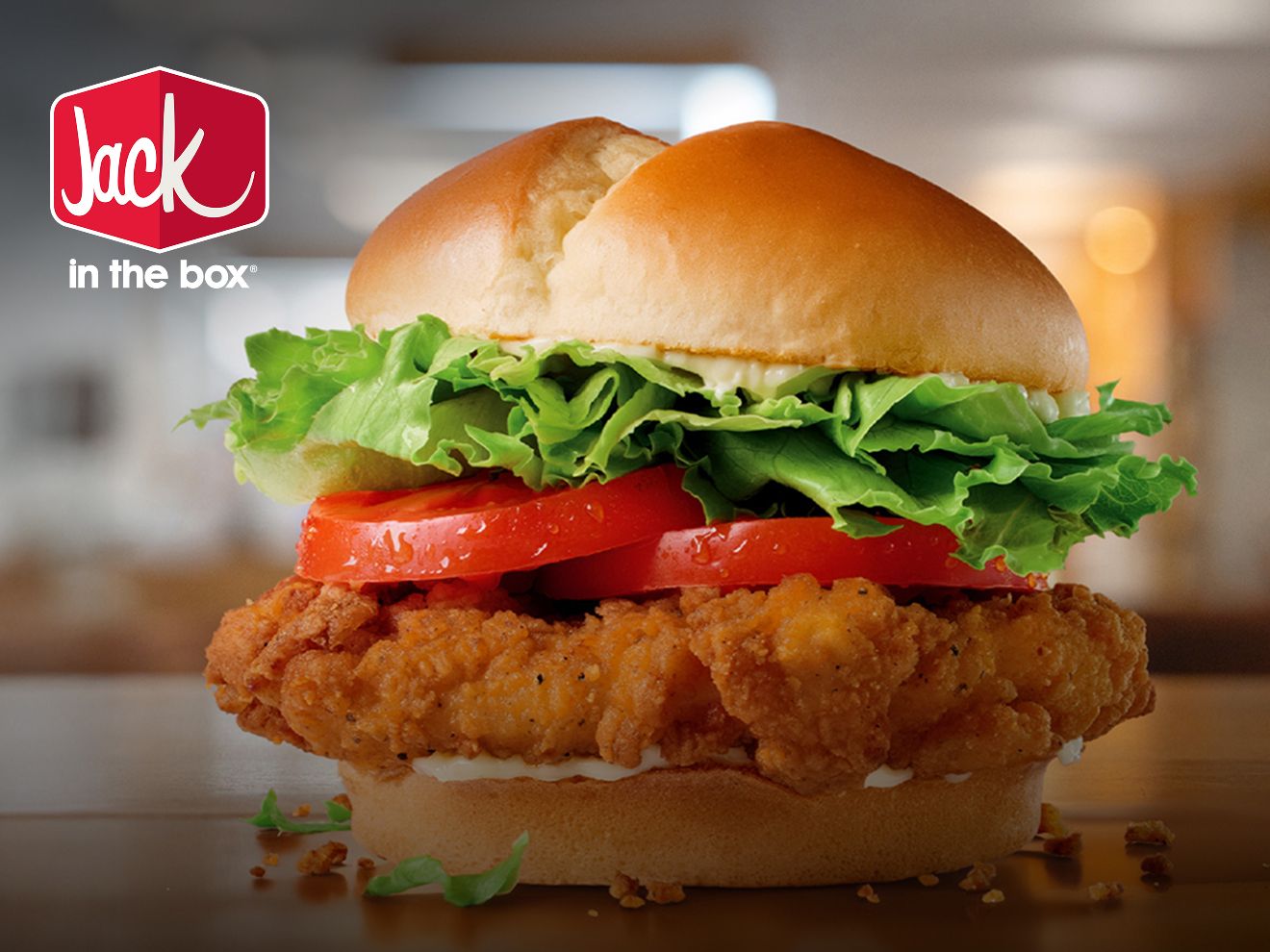 Jack in the Box Spicy Chicken sandwich with crispy chicken, lettuce, and tomato on a bun.