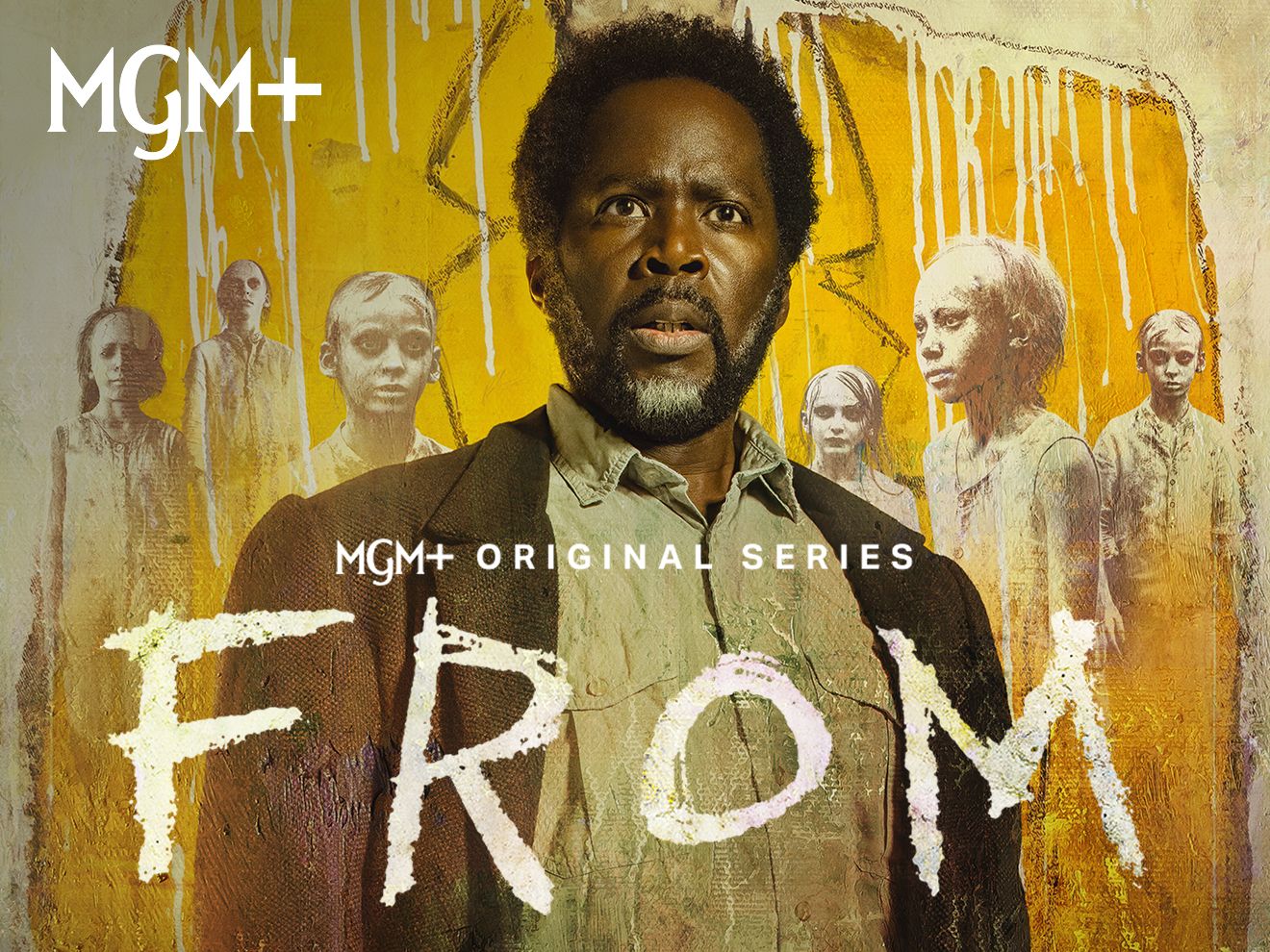 Actor Harold Perrineau featured in the MGM+ original series called "From." Behind him, there's artwork with a yellow suit and eerie characters from the show.