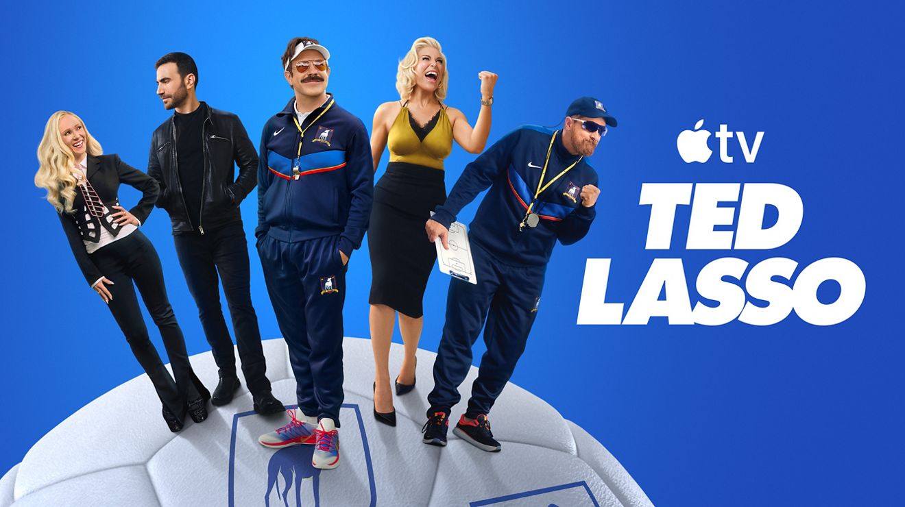 Apple TV+ promotional graphic featuring the cast of Ted Lasso standing on a soccer ball against a blue background.