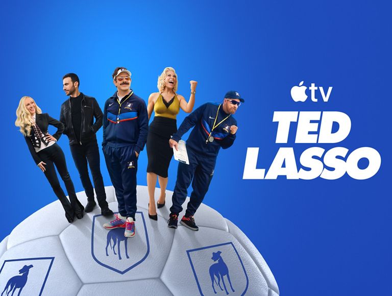 Apple TV+ promotional graphic featuring the cast of Ted Lasso standing on a soccer ball against a blue background.