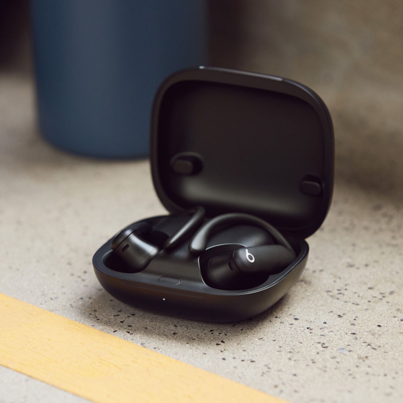 Beats headphones sit open on a countertop.