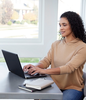 A woman typing on a computer