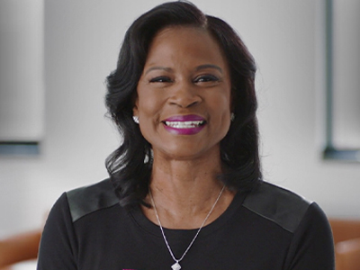 Joyce Christanio wears a black T-shirt and smiles into the camera.