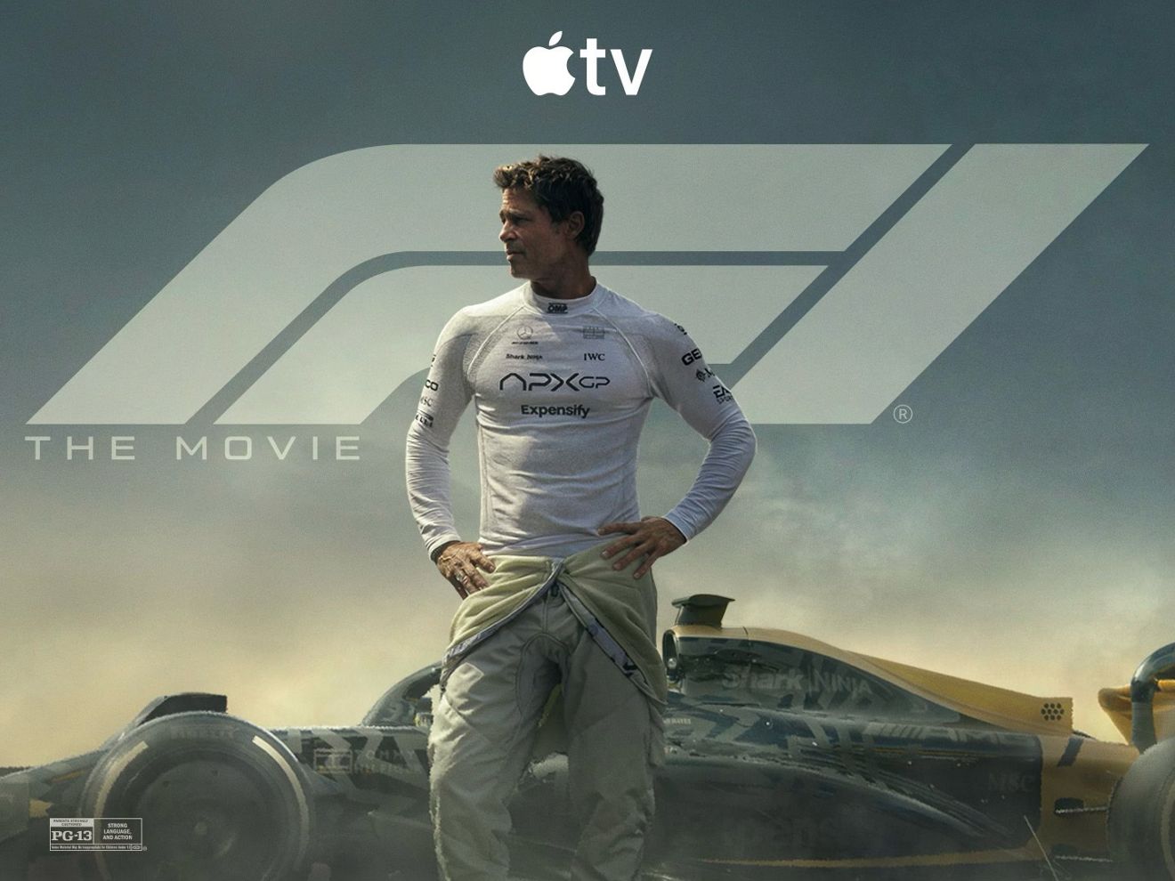 Man in a racing suit standing beside a Formula 1 car, promoting Apple TV content.