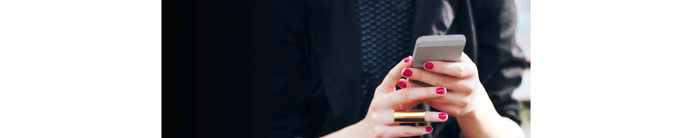 A person holds a smartphone, illustrating the kind of phone-based account access criminals target through SIM swapping