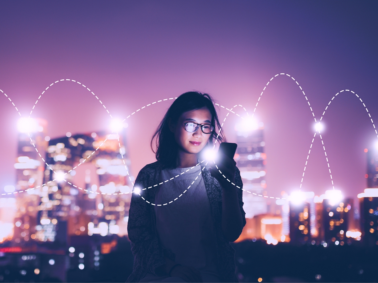 A woman’s smartphone connects with two intersecting paths of light that surround her. 