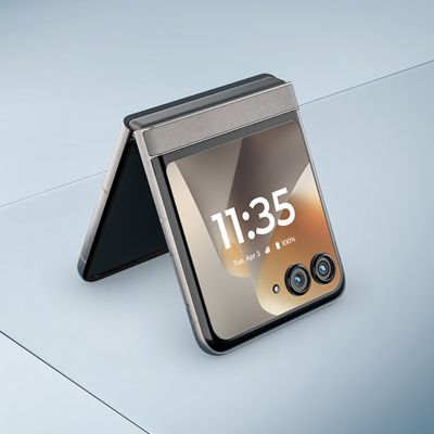 Motorola razr shown partially open, splashing through water with the display facing upward.