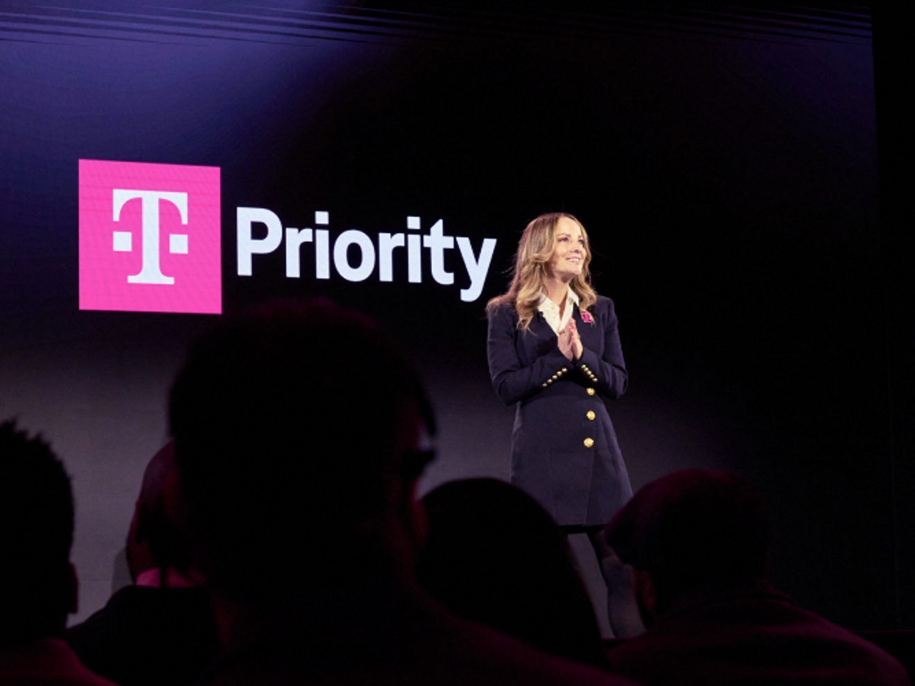 Callie is on stage, smiling at a crowd.