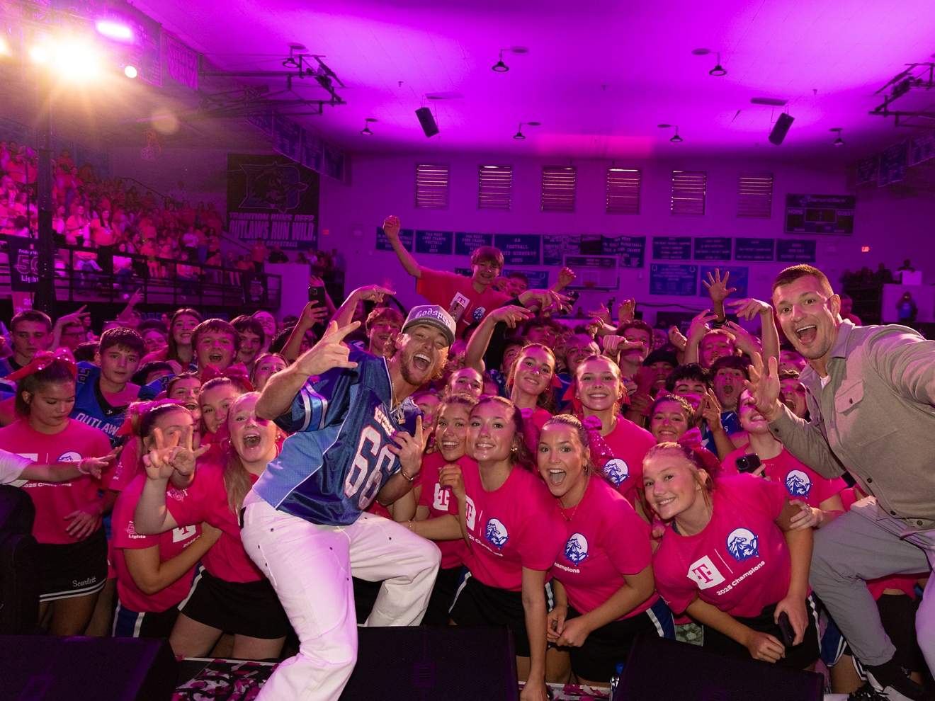A group of people decked out in magenta pose for a photo. 