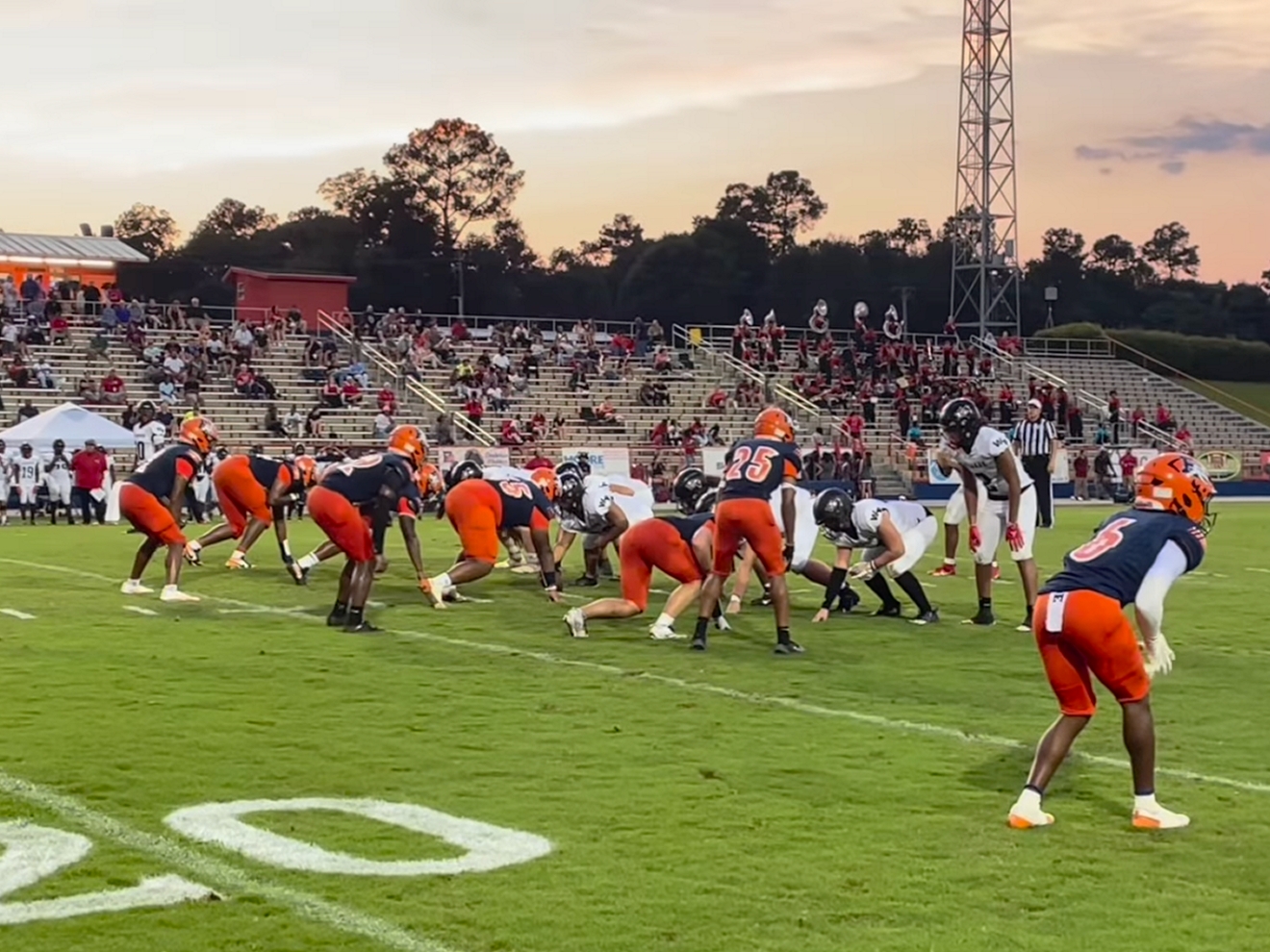 Two teams get into position on the field. 