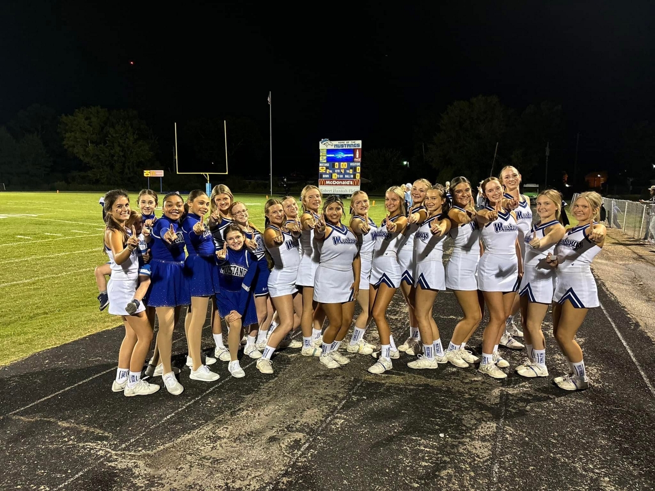 A group of cheerleaders pose for a photo. 