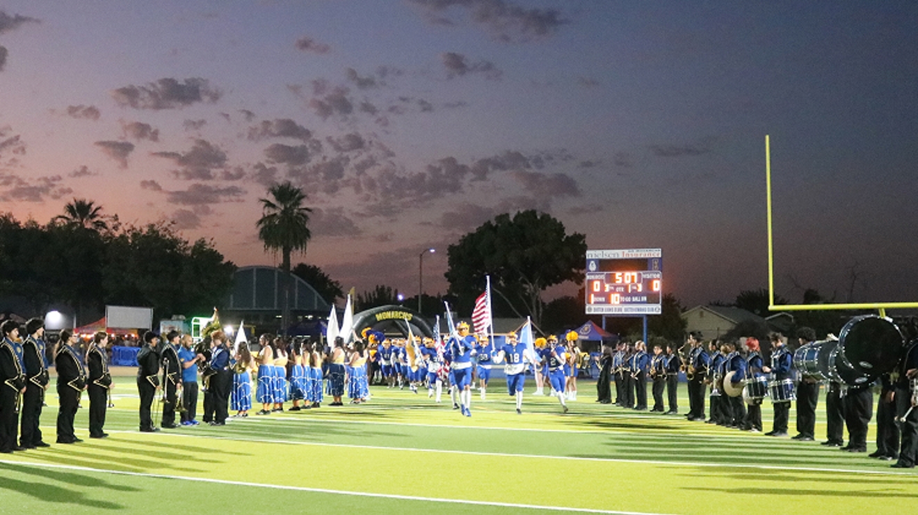 The Exeter Union High School football team and band take places on the field.