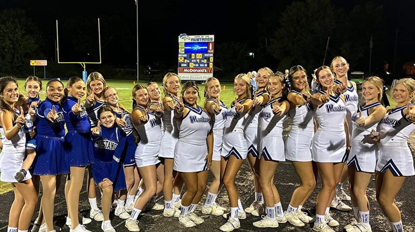 A group of River Oaks cheerleaders in blue and white uniforms.