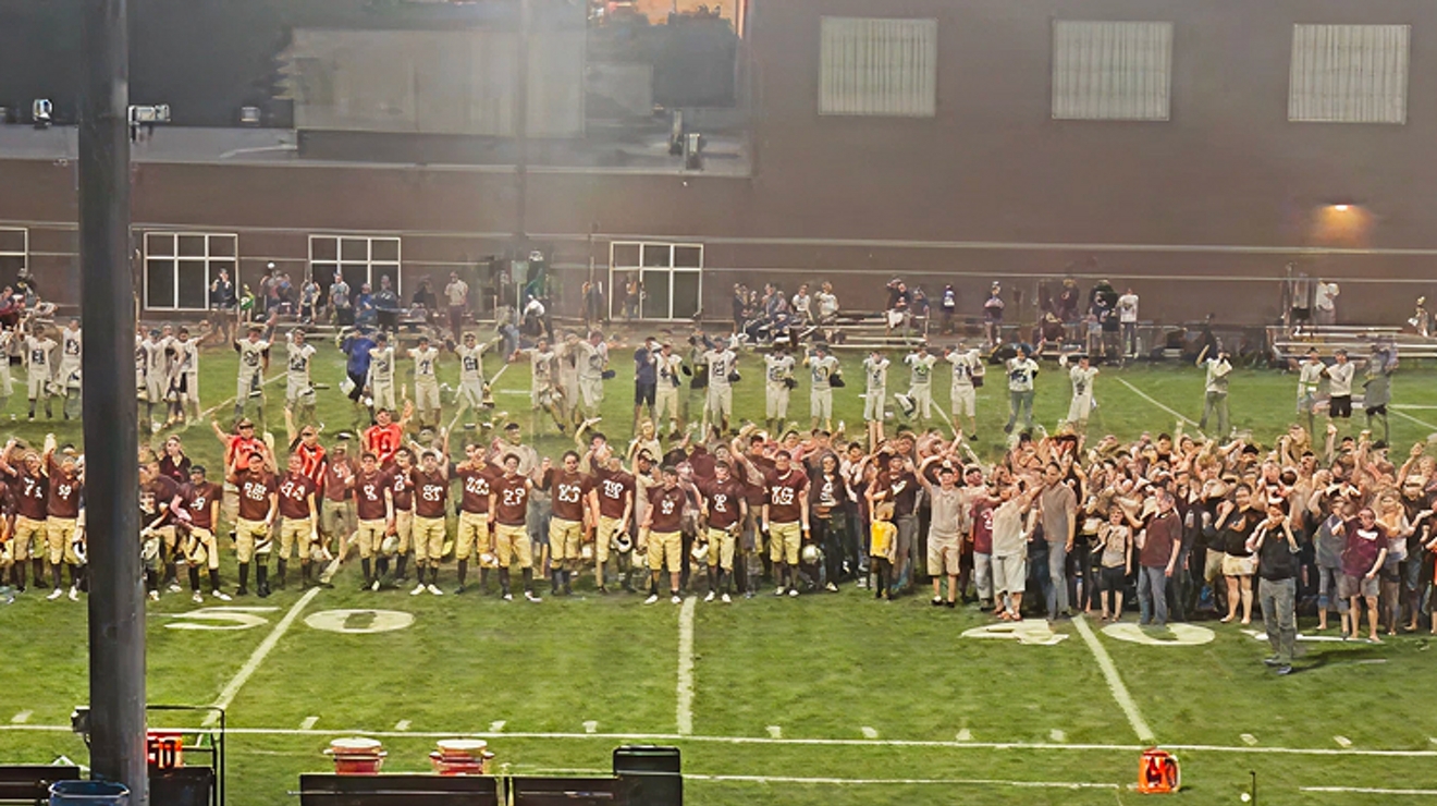 The Royalton High School football team and students gathered on the field.