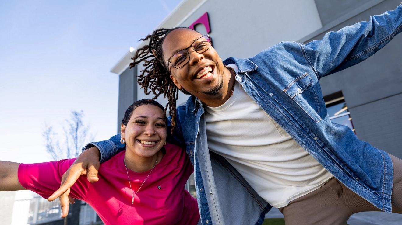 Two T-Mobile employees posing for a picture