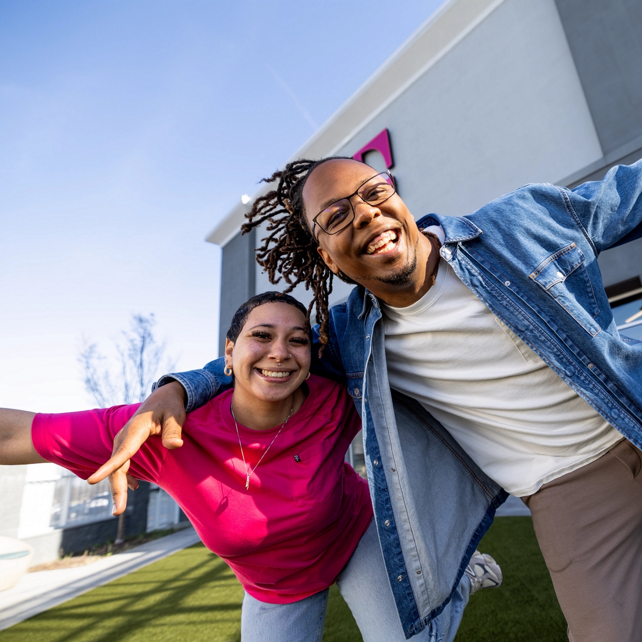 Two T-Mobile employees posing for a picture
