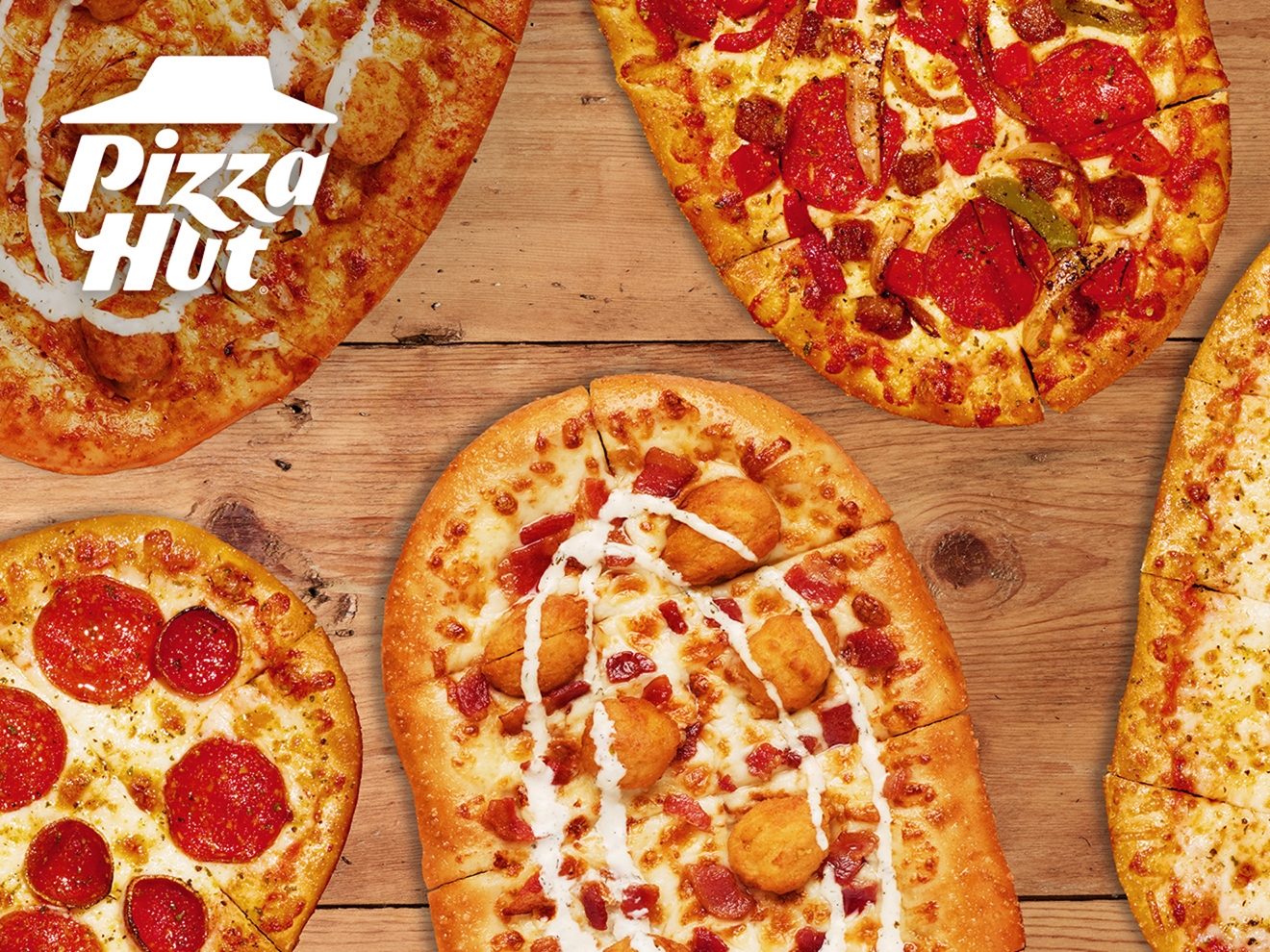 A collection of 5 different Pizza Hut Crafted Flatzz on a wooden surface.