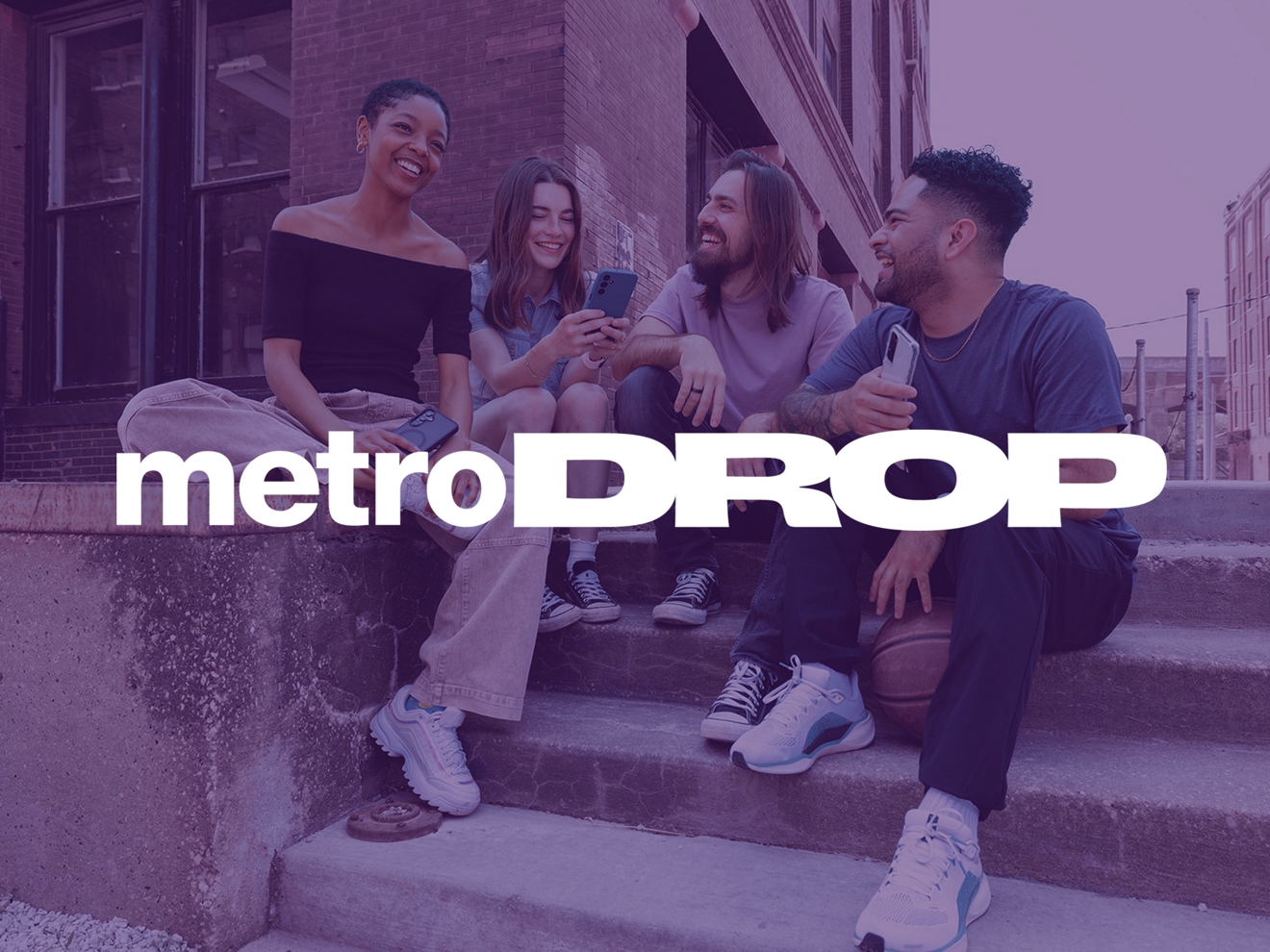 Group of young people hanging out and laughing on the corner of an urban setting