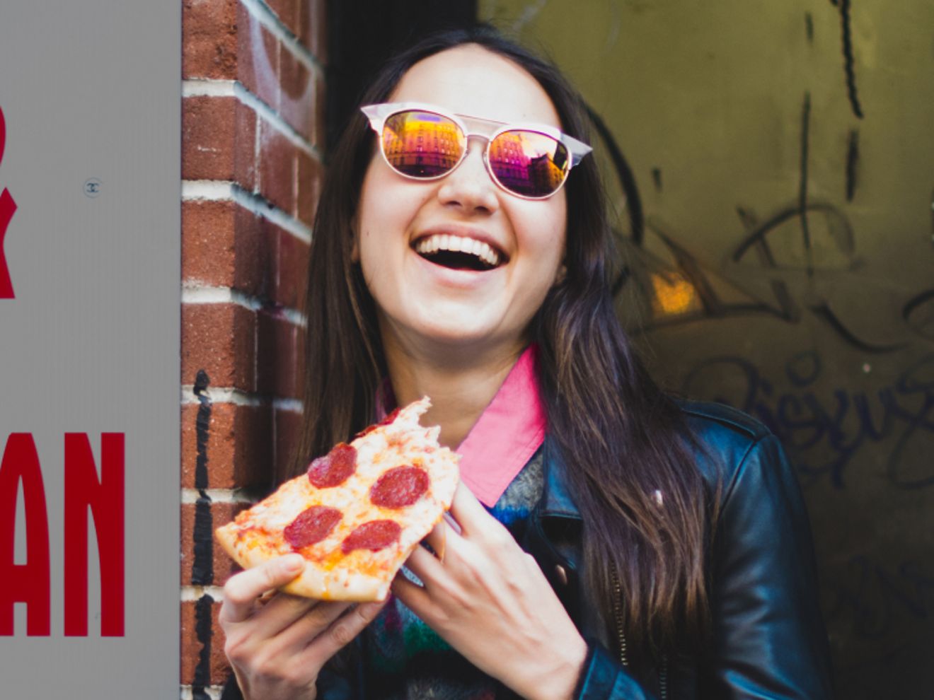 A person enjoys a slice of pepperoni pizza.