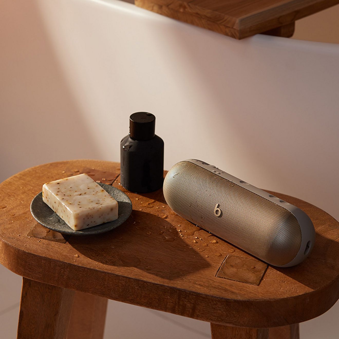 Beats pill sits on side table along with everyday essentials.