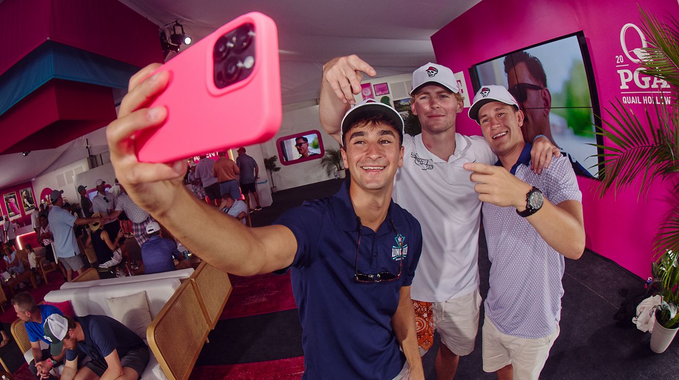 Three T-Mobile members posing for a selfie inside Club Magenta. 