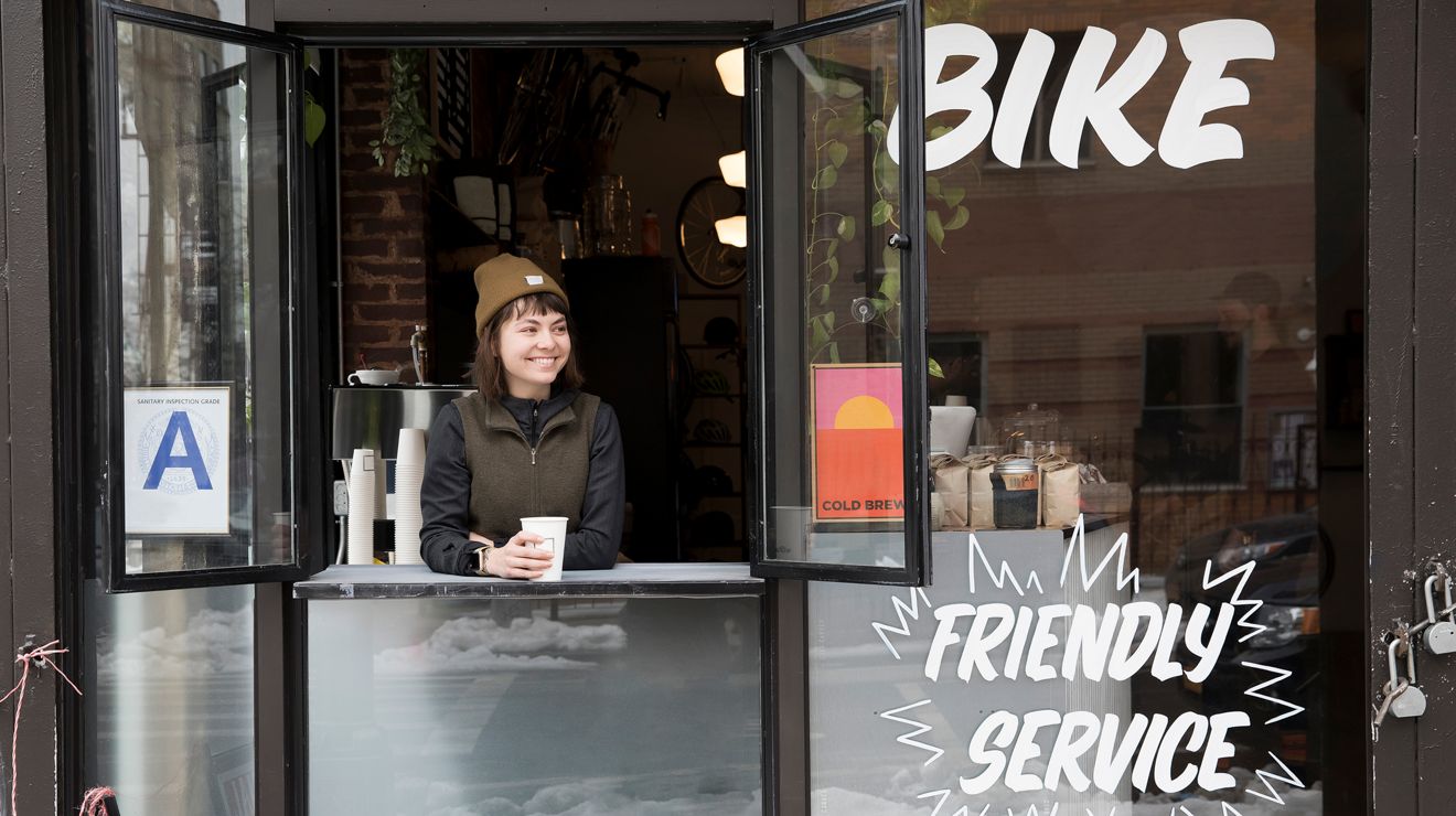 A small business owner runs a connected coffee shop with reliable network service.