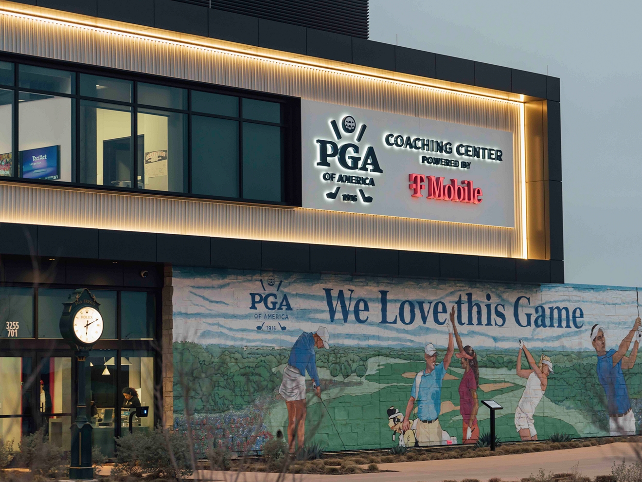 Large golf-themed mural on the front exterior wall of the Coaching Center. 