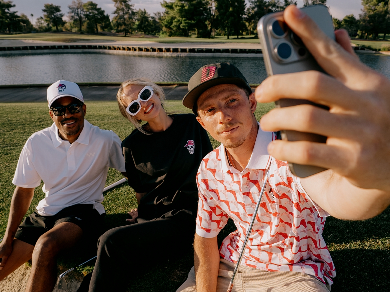 Three stylishly dressed golfers taking a selfie.