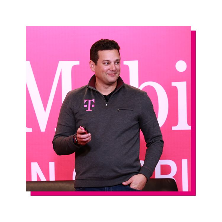 Mike Katz standing in front of a magenta T-Mobile banner