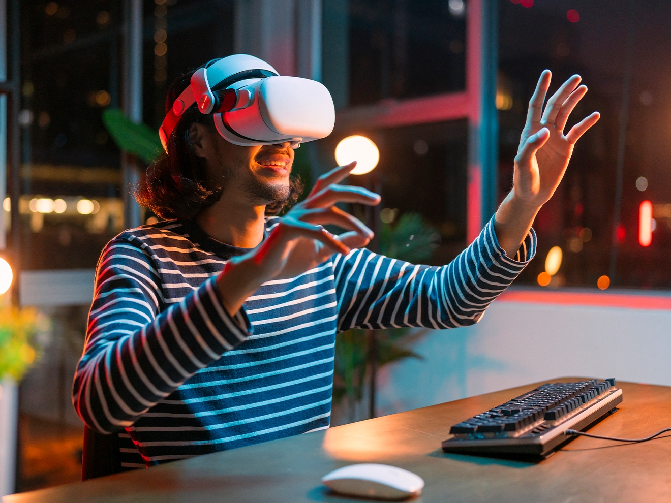 Young adult wearing a VR headset and smiling.