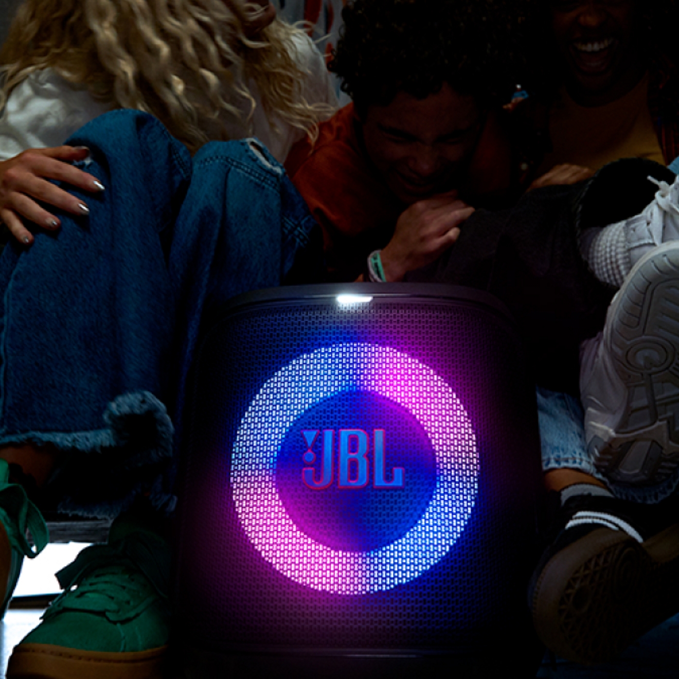 A close-up image of a JBL speaker glowing two colors