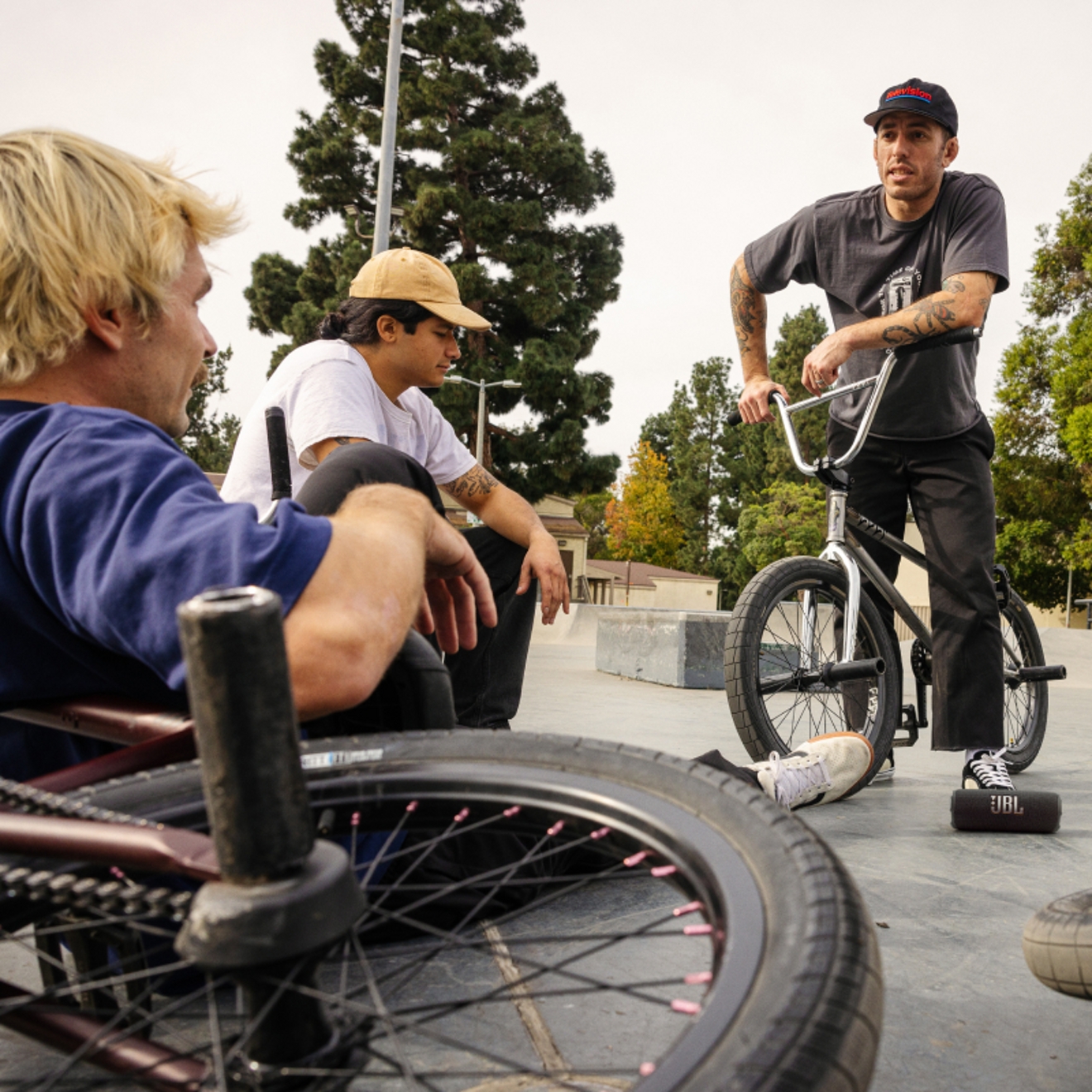 Three friends on bikes listening to a JBL Flip 7 device