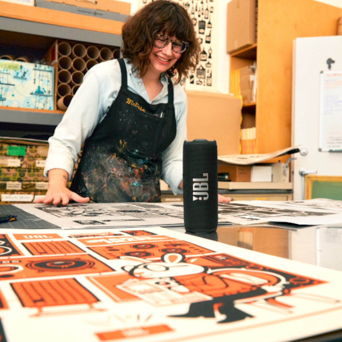 A woman listening to her JBL Flip 7 device while at work