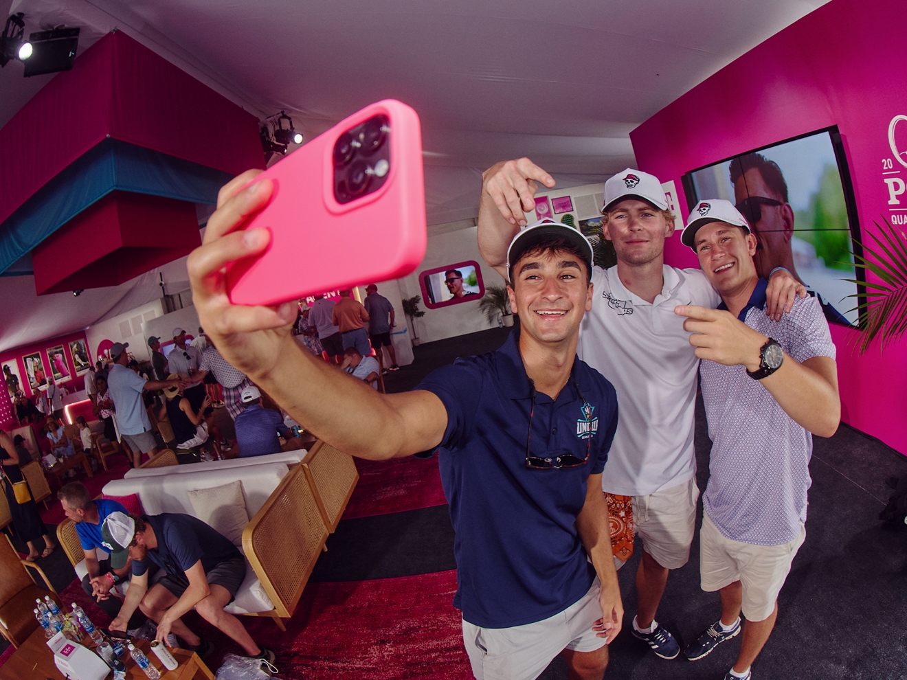 Three friends taking a group selfie inside Club Magenta. 