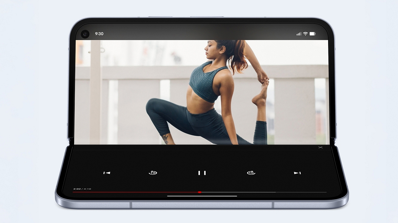 A Google Pixel 10 Pro Fold sitting half opened, showing a yoga video on one of its screens.