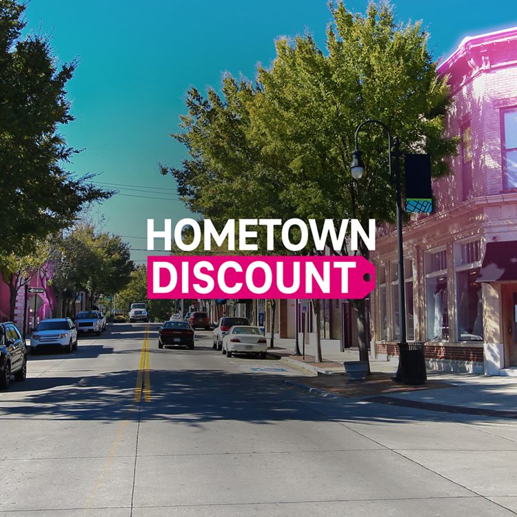 Main street in a small town with some buildings highlighted with magenta accents and the Hometown Discount logo overlayed